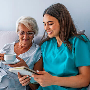 nurse reading to old woman